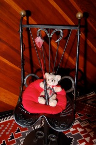 Our little corseted teddybear sits in her "Queen of Hearts" chair after enjoying her very first scene!